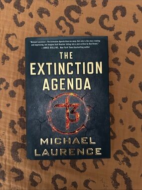 The Extinction Agenda by Michael Laurence - Black Cover with Gold Text
